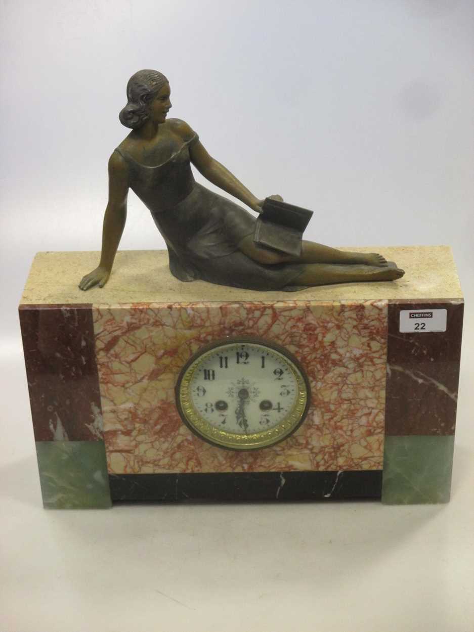 An Art Deco marble mantle clock, surmounted with a reclining female figure