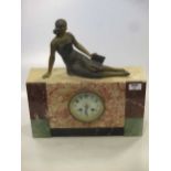 An Art Deco marble mantle clock, surmounted with a reclining female figure