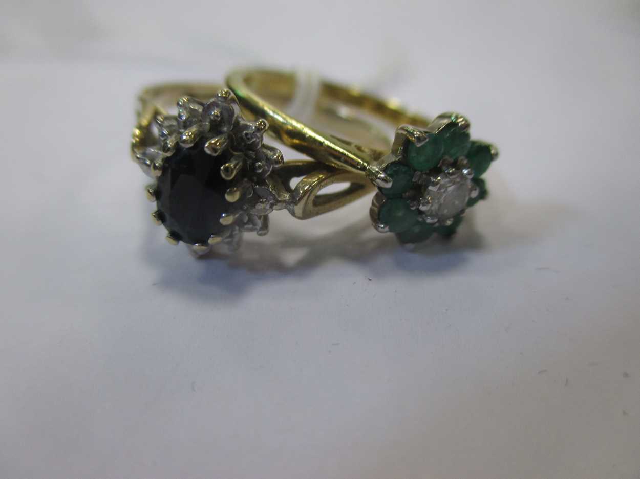 An emerald and diamond cluster ring together with a sapphire and diamond cluster ring (2)