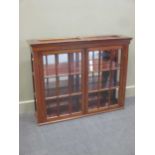 A mahogany table top two door shop display cabinet