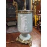A 19th century gilt metal mounted celadon ground vase lamp base, decorated in white with flowers and