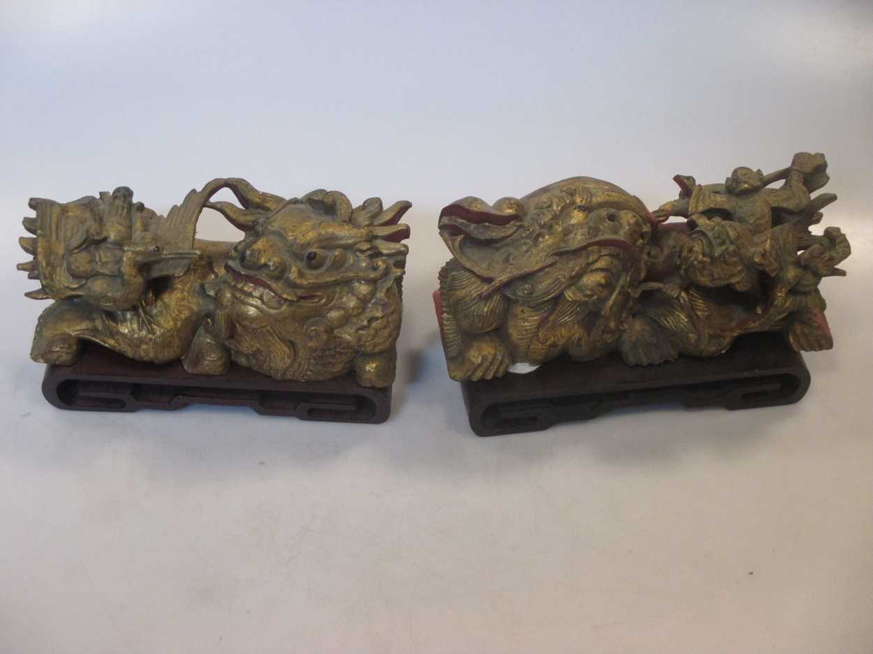 A pair of Chinese carved giltwood dragons