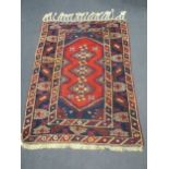 A Turkish blue and red rug with ivory tassels, 206 x 130cm,