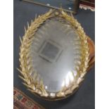 An oval moulded resin 'antler' frame wall mirror (some damage)