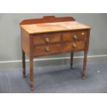 A Gillows style mahogany dressing table fitted with three drawers on reeded legs, with adapted