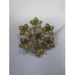 Edwardian six leaf 15ct gold brooch set with pearls centred by a ruby within 4 pearls, stamped '
