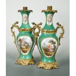 A pair of porcelain and gilt metal mounted two-handled lamps,