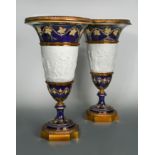 A pair of Sévres porcelain and metal mounted pedestal vases,