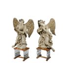 A large and imposing pair of carved and painted angels, probably late 17th century,