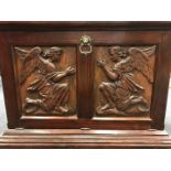 A pair of carved oak panels of kneeling angels,
