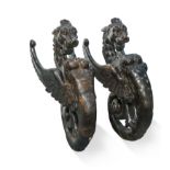 A pair of late 16th or early 17th century carved gryphon-type mounts,