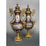 An impressive pair of French porcelain, two-handled ormolu vases and covers, probably Sevres,