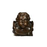 An imposing carved cherub head wall mount, late 17th or early 18th century