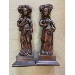 A pair of carved oak caryatids, probably 17th century,