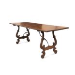 An Italian trestle dining table with wrought iron supports,