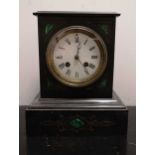 A late Victorian black marble and malachite inlaid mantel clock,