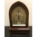 An Edwardian mahogany and boxwood strung lancet top mantel clock,