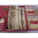 A pink jewellery box containing a collection of 9ct gold jewellery including two wedding rings, a