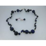 A row of lapis lazuli beads together with a pair of ruby and diamond earpendants (2)