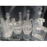 A collection of ten cut glass jugs and decanters