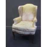 A French wing armchair on cabriole legs