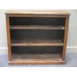 A leather studded bookcase with adjustable shelves on a plinth base 106 x 117 x 36cm