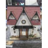 A collection of modern scratch built doll's houses, including village shop, most with contents