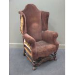 A large Queen Anne style walnut framed wing back arm chair