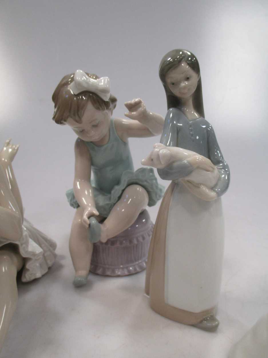 Four Lladro figures, to include a Ballerina, a girl holding a pig etc - Image 7 of 9