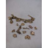 A charm bracelet marked '9ct' with a quantity of charms 71.2g