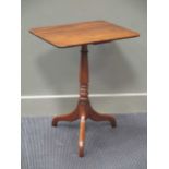 A George III mahogany wine table, with a rectangular top above a turned pedestal on three