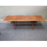 A burr walnut rectangular occasional table on two turned and tapered supports 41 x 142 x 45cm