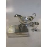 A silver sauce boat, a silver egg cup and a silver table cigarette case (3)