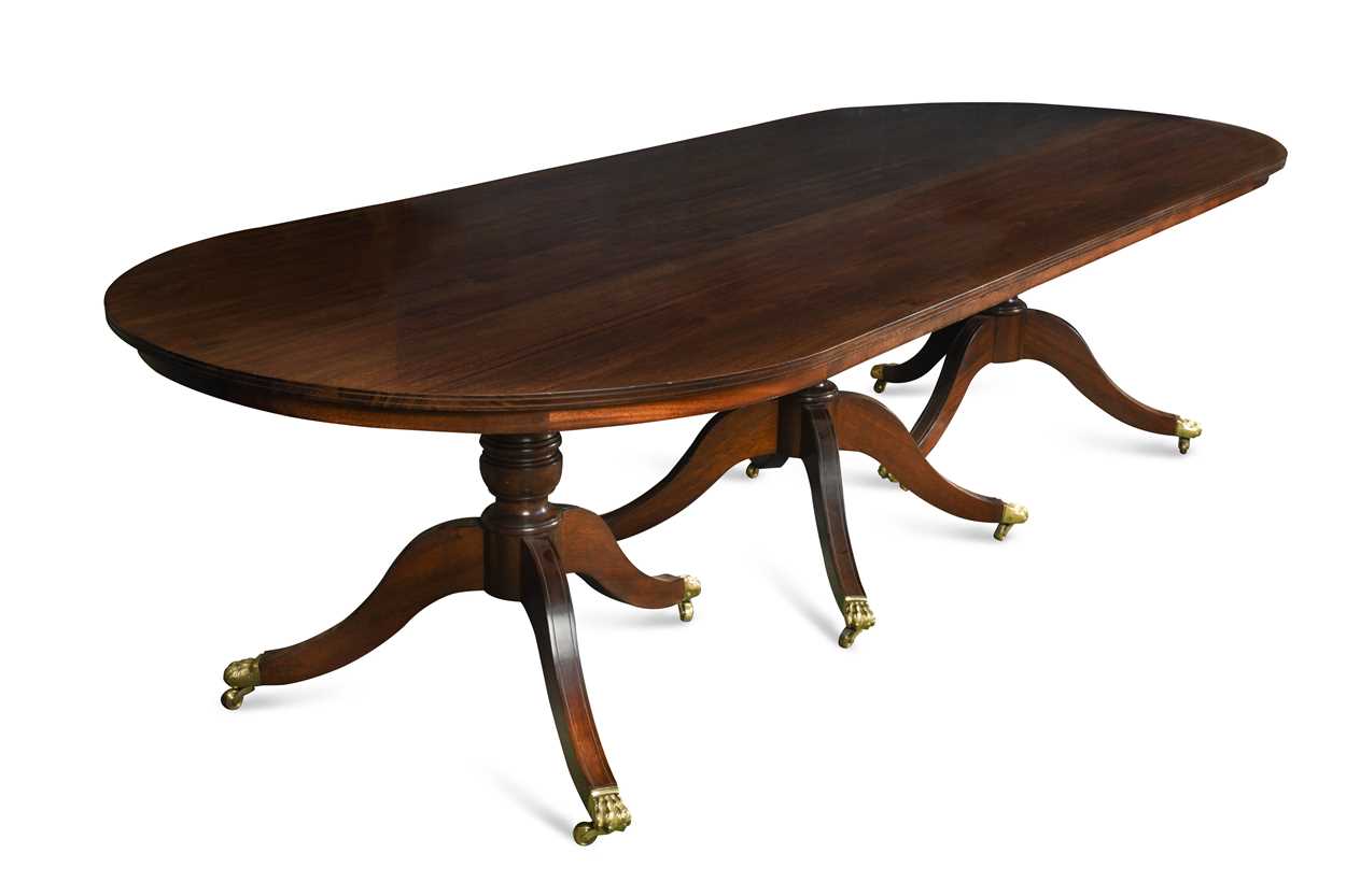 A mahogany three pedestal dining table with one piece top,