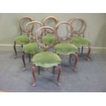 A set of six Victorian walnut balloon back chairs