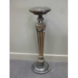 An ebonised and parcel gilt pedestal with circular top, late 19th century 104cm high