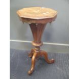 A Victorian walnut trumpet work table with assorted sewing related contents