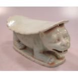 A Chinese green glazed head rest with feline support, 12cm high