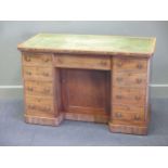 A Victorian mahogany leather topped desk, the frieze fitted with nine drawers and a central