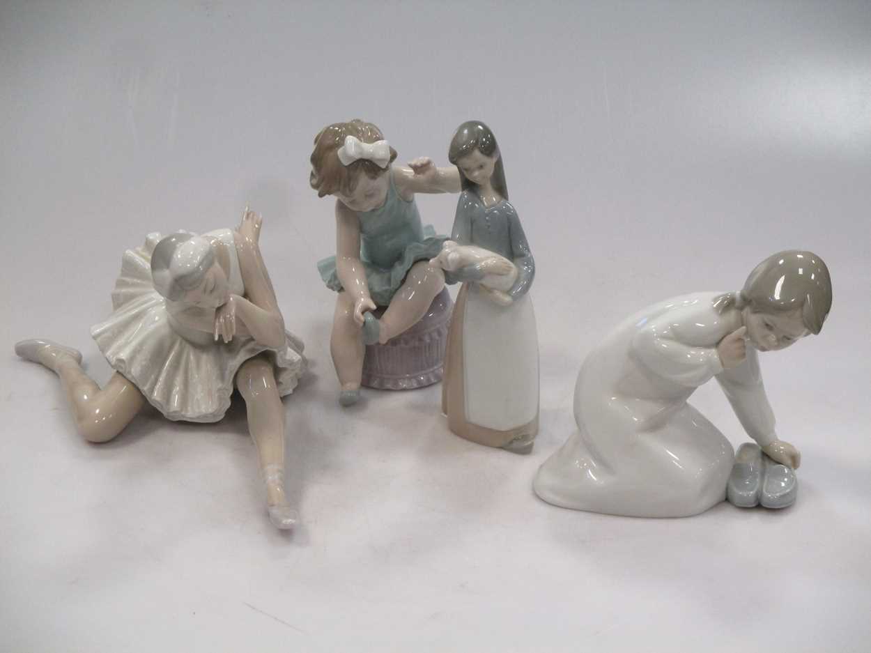 Four Lladro figures, to include a Ballerina, a girl holding a pig etc