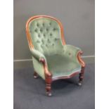 A Victorian walnut nursing chair, with buttoned back and stuffed over scrolled arms