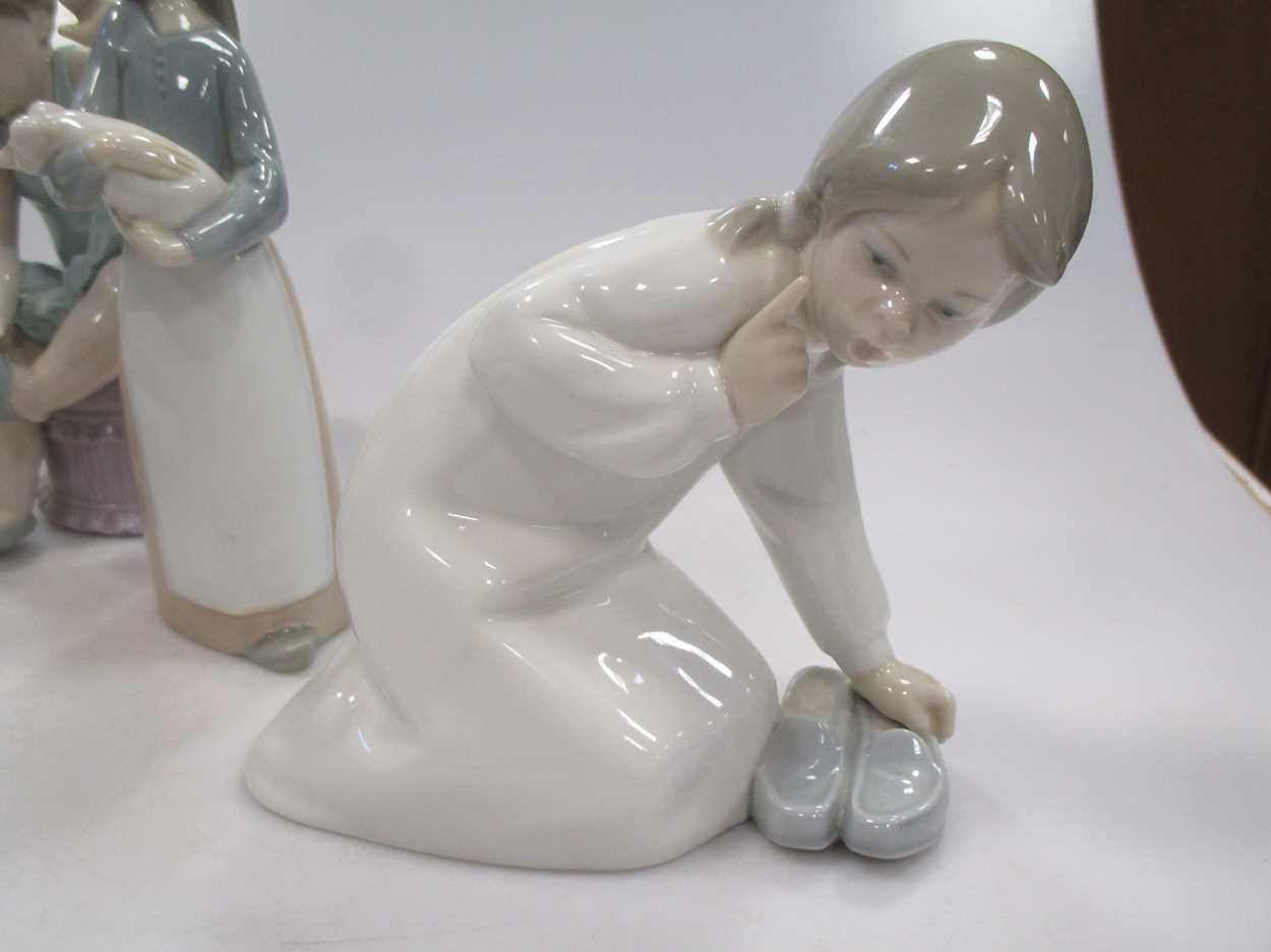 Four Lladro figures, to include a Ballerina, a girl holding a pig etc - Image 9 of 9