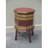 A George III mahogany and brass bound octagonal cellarette on stand, with brass side handles