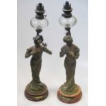 A pair of French Art Nouveau patinated spelter figural lamps