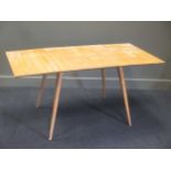 A pale wood (possibly maple) extending table on tapered legs, 72 x 153 x 76cm
