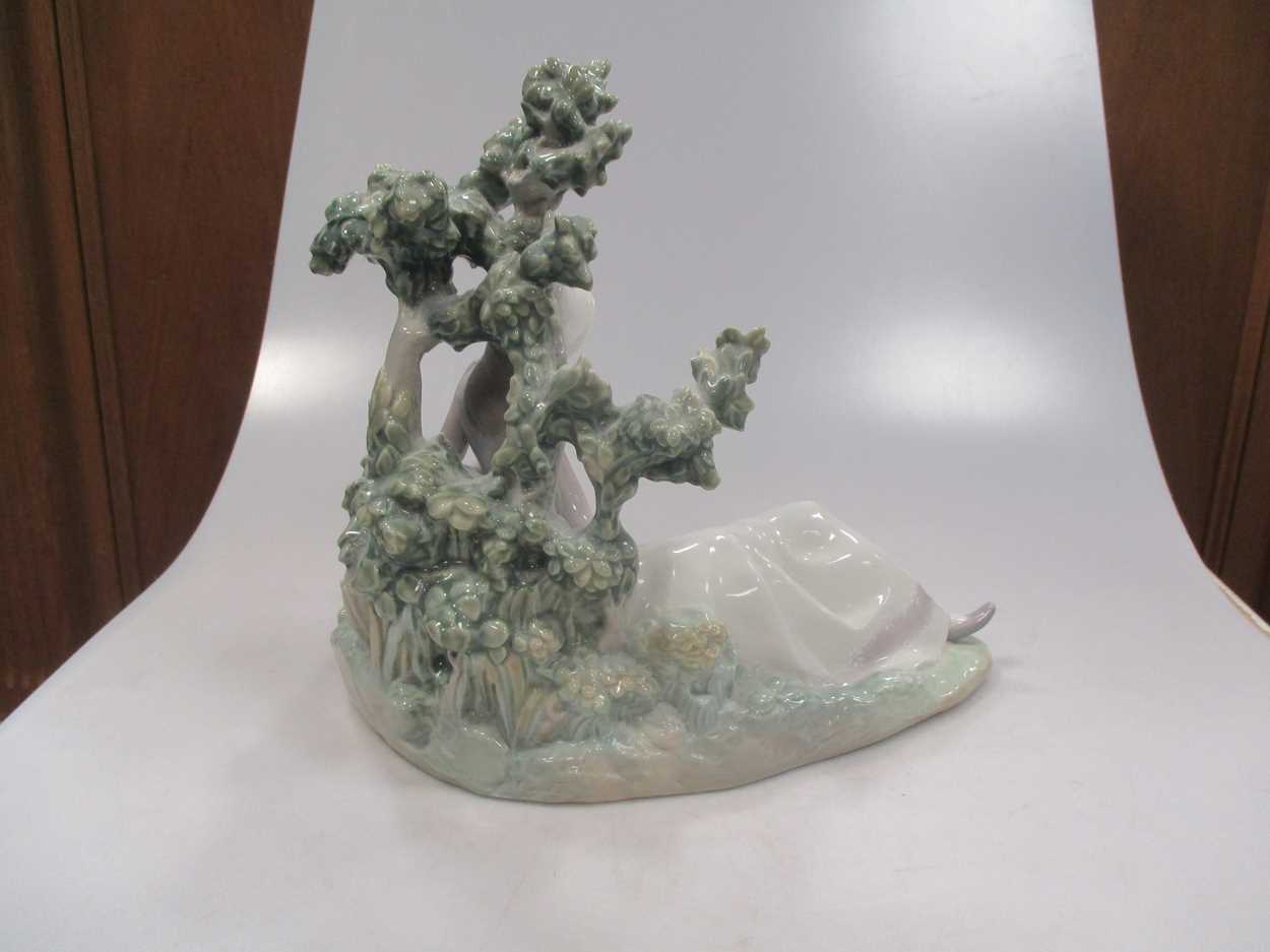 A Lladro figure of a lady reclining besides a tree - Image 3 of 7