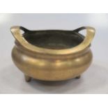 A Chinese bronze two handled censor with seal mark to base 17cm wide
