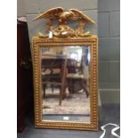 A 19th century gilt framed bevelled looking glass with eagle cresting