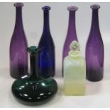 Three amethyst glass carafes, another blue glass example with etched decoration and others
