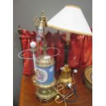 A Regency style figural table lamp, a French style painted porcelain table lamp and another (3)